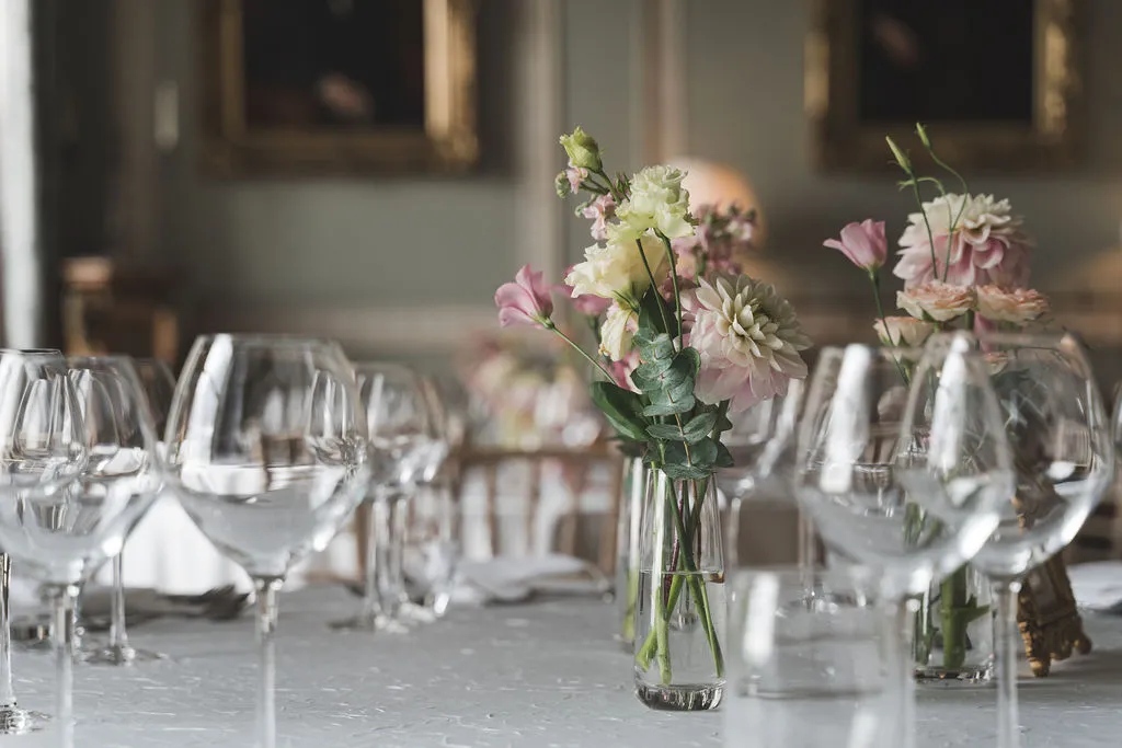 Glassware and garden flowers on a dressed dining table