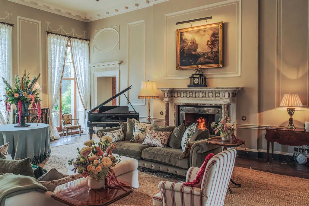 The piano room with sofas and an open fire
